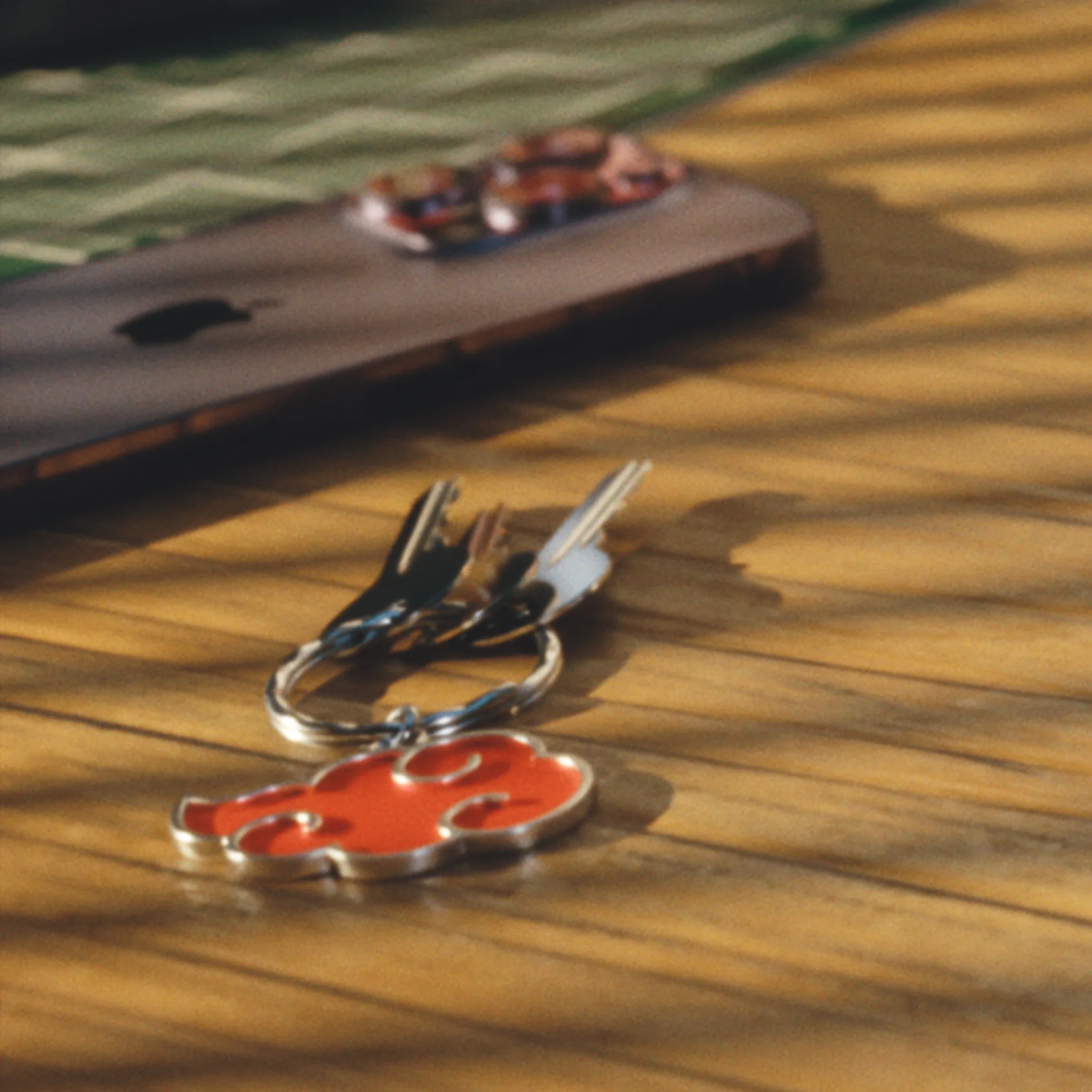 Small character keychains resting on a wooden desk