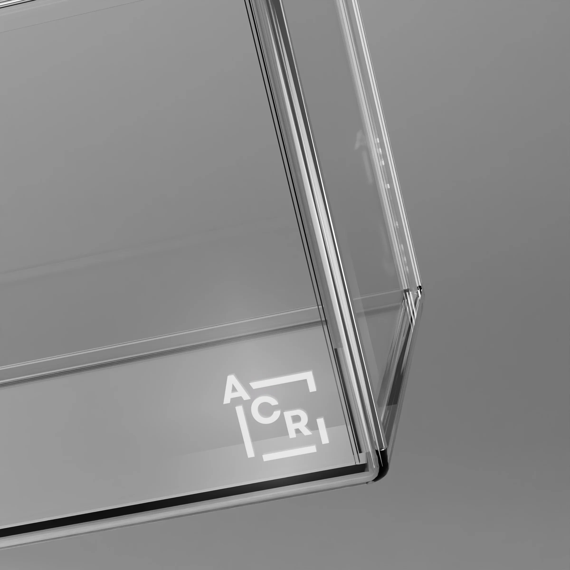 Close-up of the ACRI mark etched into a clear acrylic corner