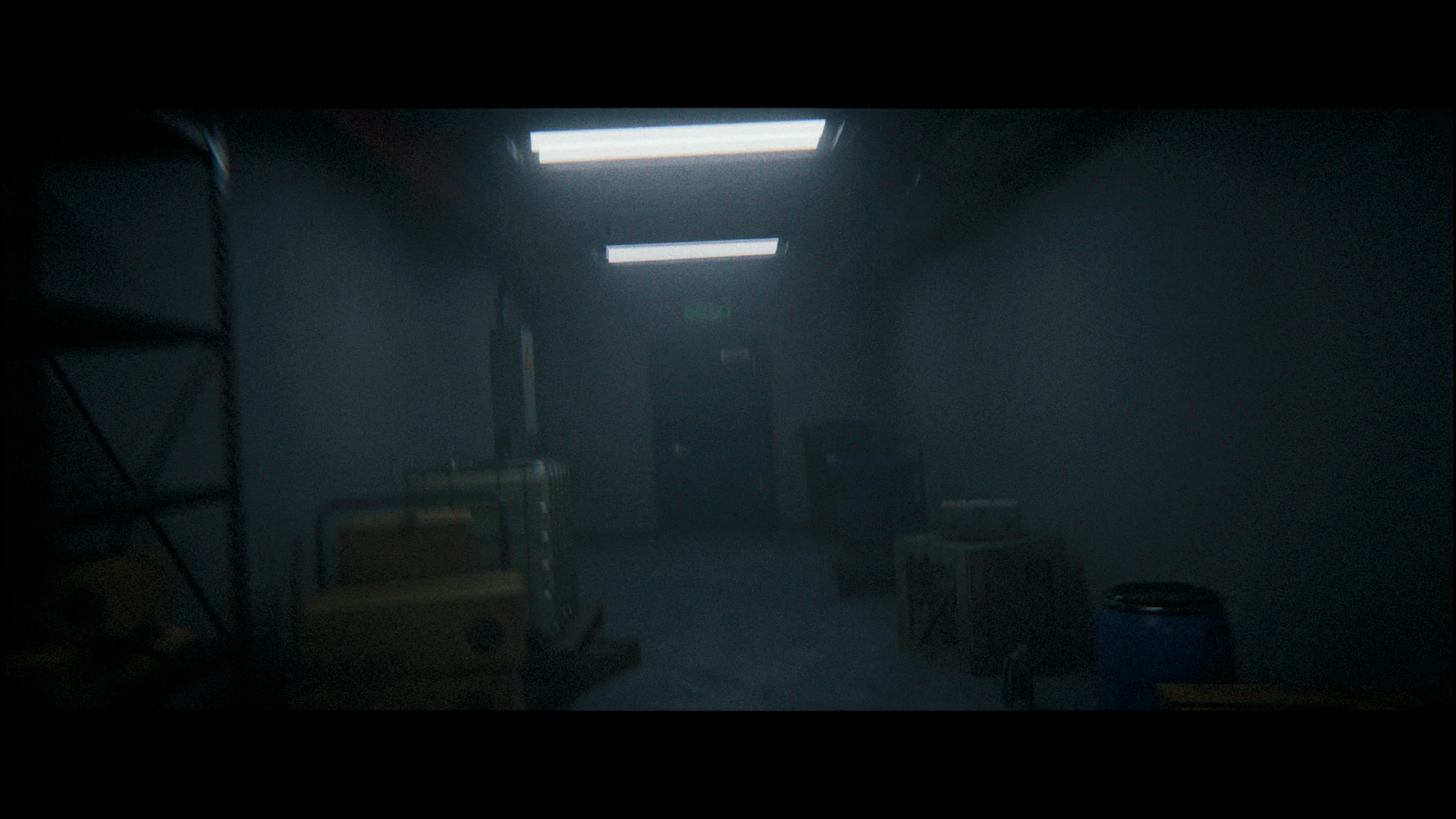 Dim industrial room lit from an overhead panel